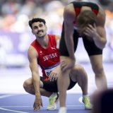 Julien Bonvin, left, and Berke Akcam of Turkey, right, react after crossing the finish line, during the men's 400m hurdles repechage Round at the 2024 Paris Summer Olympics in Paris, France, Tuesday, August 6, 2024. (KEYSTONE/Anthony Anex)